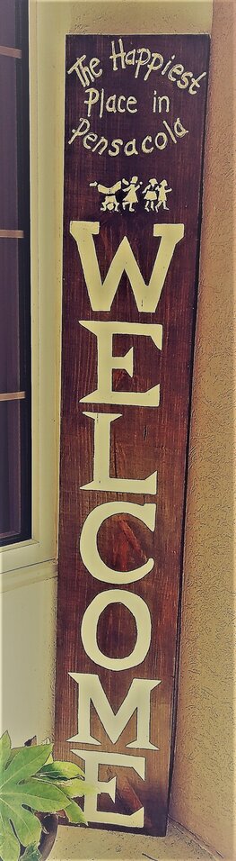 A tall, vertical, wooden sign at the entrance to St. Paul Preschool that reads, 