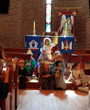 Preschoolers dressed up and performing a Christmas play in the St. Paul sanctuary.